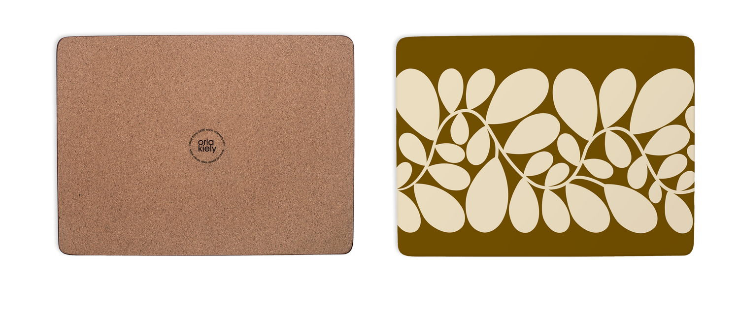 Cork mouse pad on the left and a decorative placemat with leaf pattern on the right.