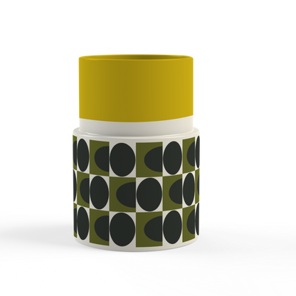 Container with yellow top and black and green patterned body on a white background