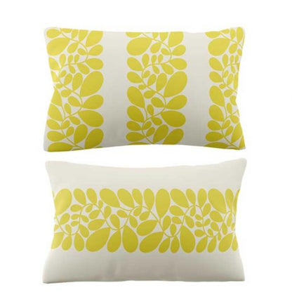 Two decorative pillows with yellow leaf pattern on a white background