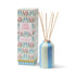 Reed diffuser with packaging featuring floral design on a white background