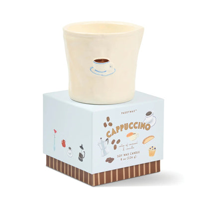 Cappuccino-themed candle in a decorative box on a white background
