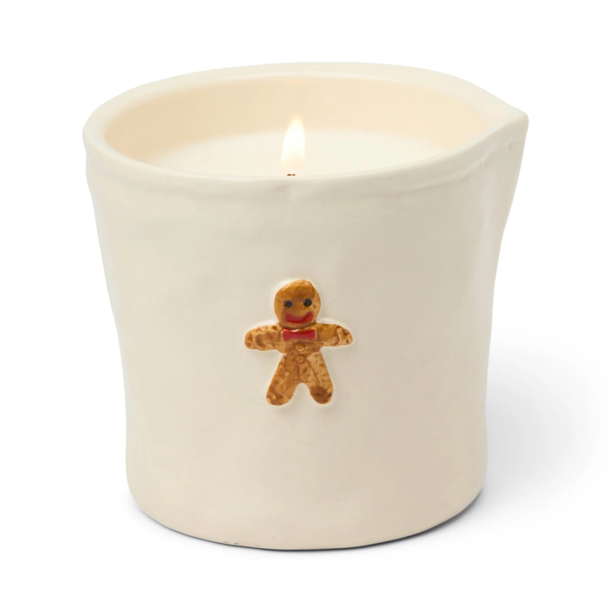 Candle in a white container with a gingerbread man decoration on a white background