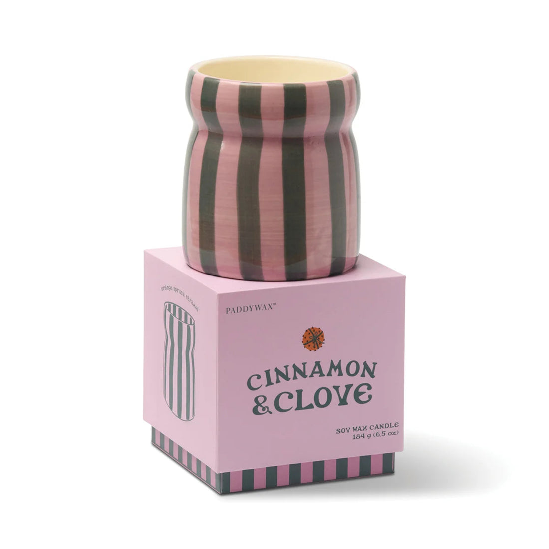 Striped candle on a pink box labeled &
