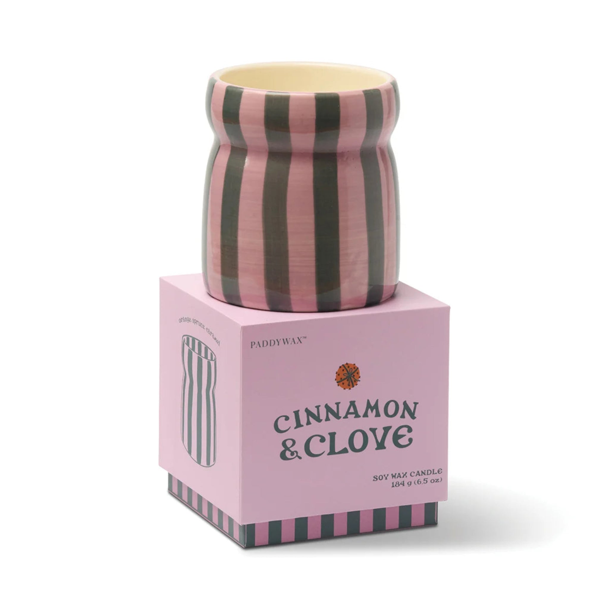 Striped candle on a pink box labeled &