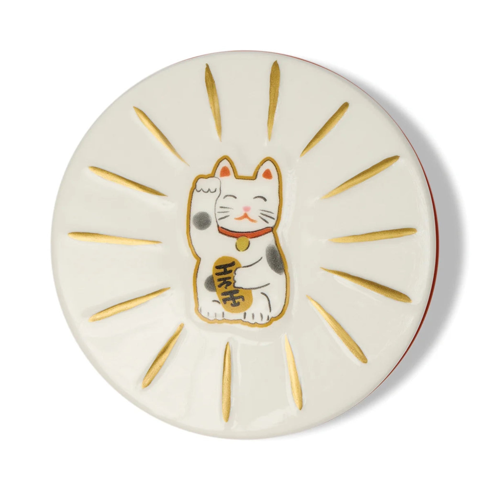 Round ceramic plate with a cartoon cat design and gold accents on a white background