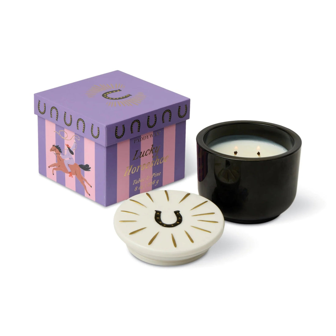 Black candle with white lid, purple decorative box, and pink and purple striped packaging on a white background