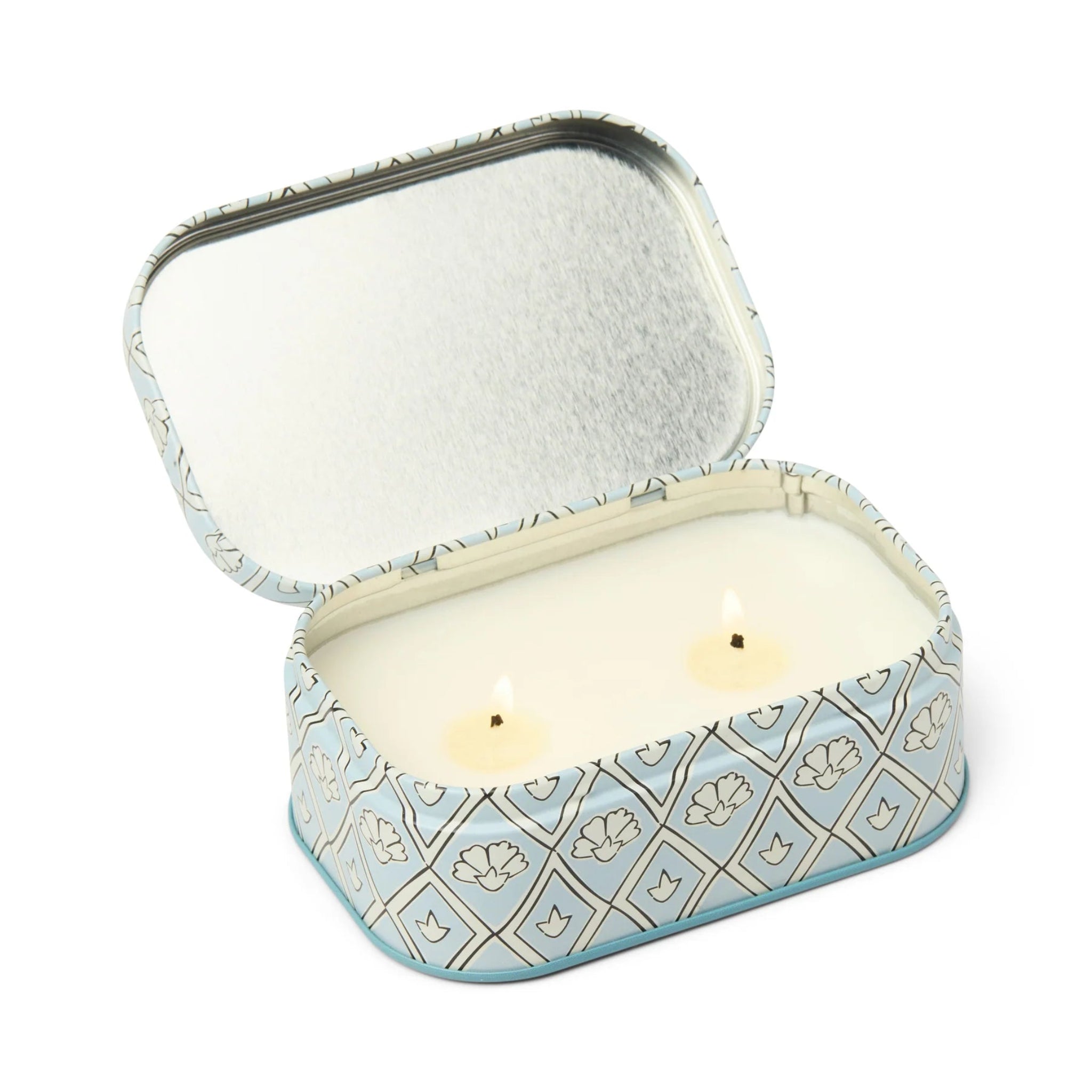 Decorative tin with a candle inside on a white background