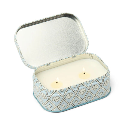 Decorative tin with a candle inside on a white background