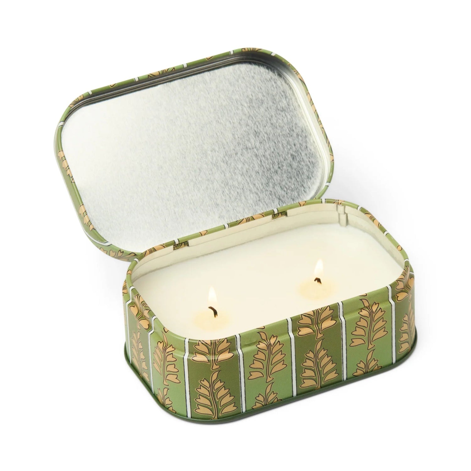 Candle in a decorative tin with a leaf pattern on a white background