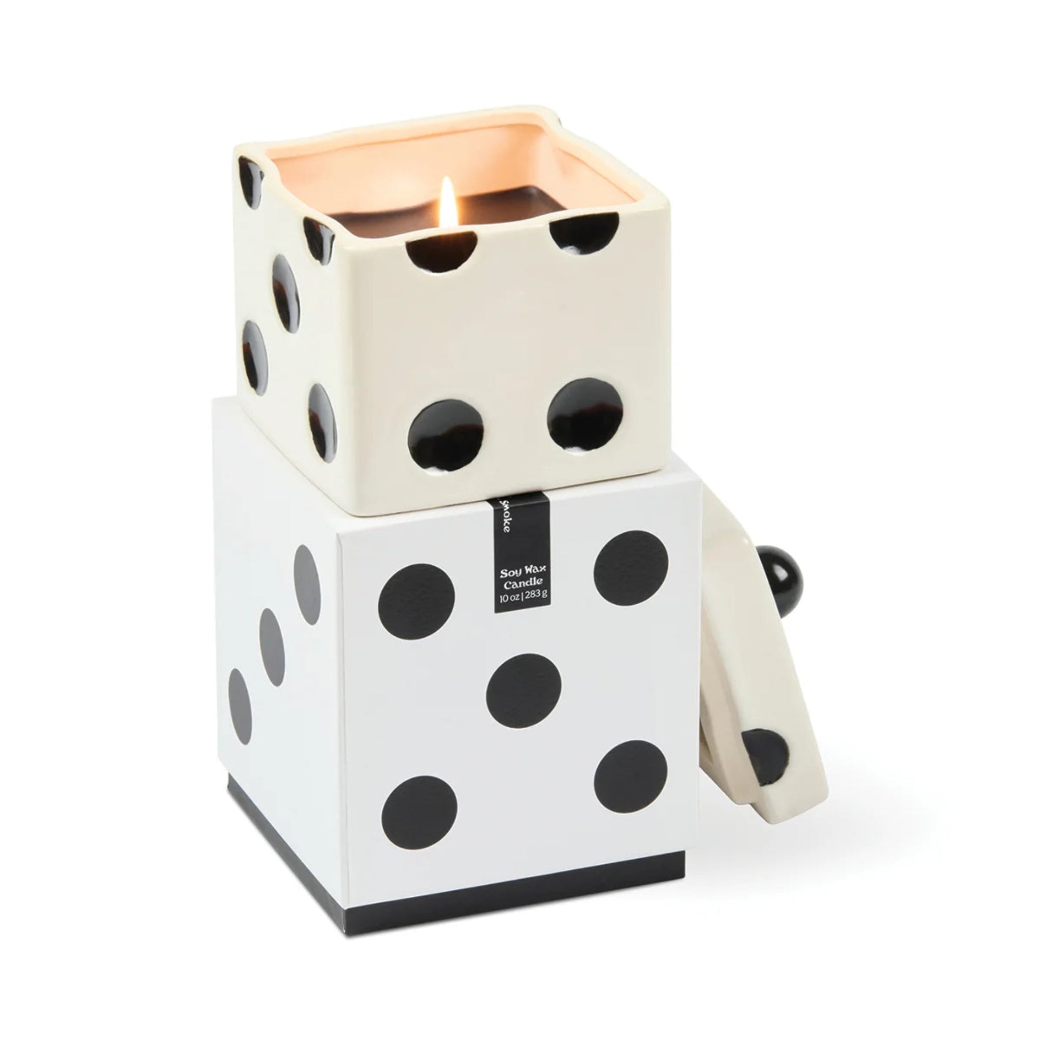 A dice-themed candle holder and container by Mon Mar Chantier, featuring a white and black polka-dot dice design with a lit candle inside a square top compartment, shown on a clean white background.