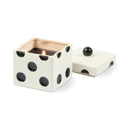 Ceramic dice-shaped candle with black dots on a white background