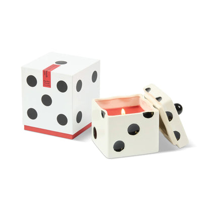 Dice-shaped candle with a matching box on a white background