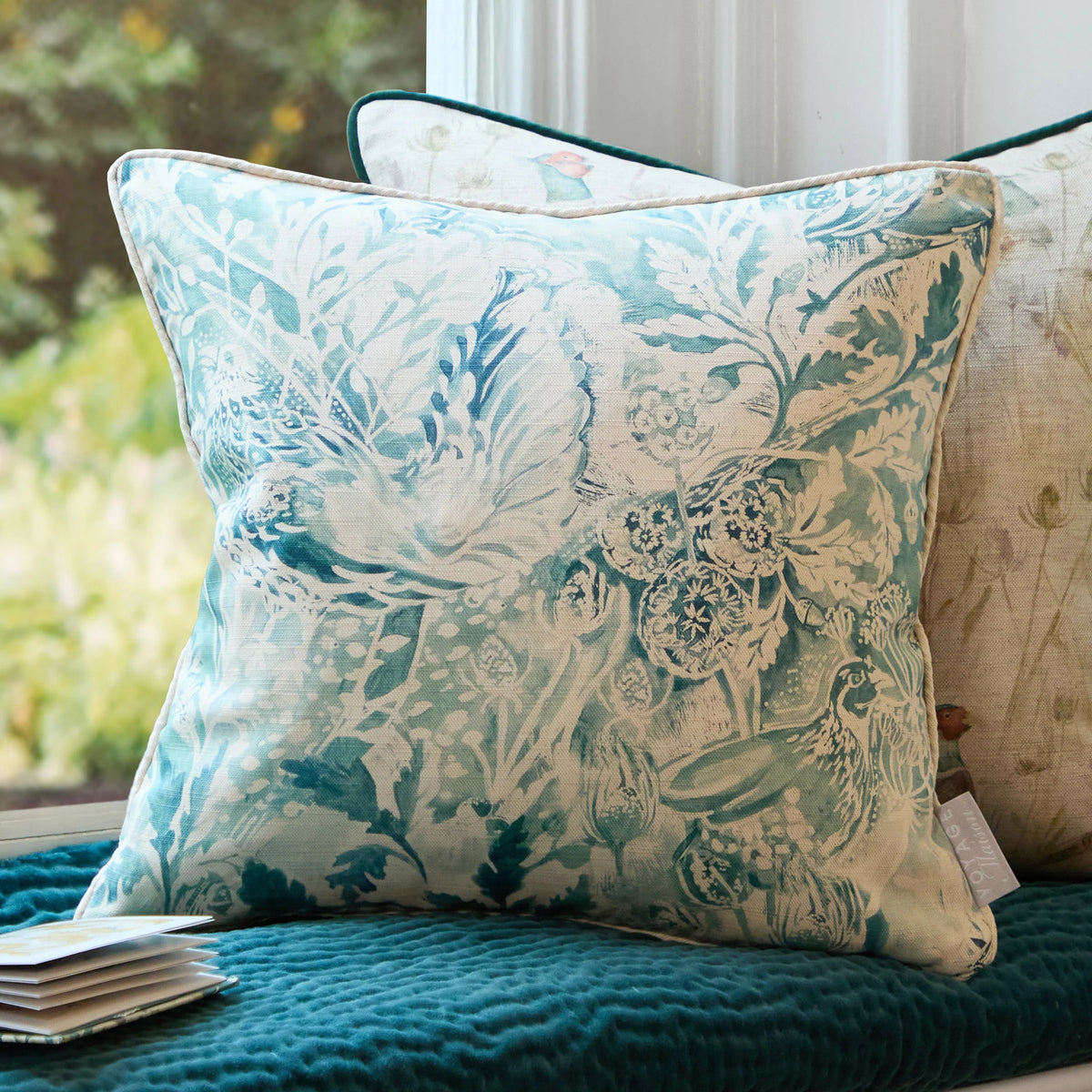 a group of pillows on a window seat
