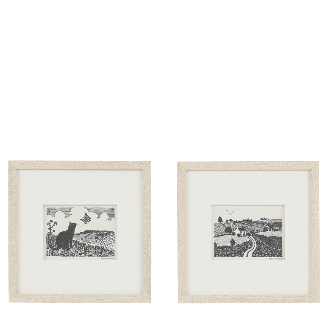 Two framed black and white prints of landscapes on a white background