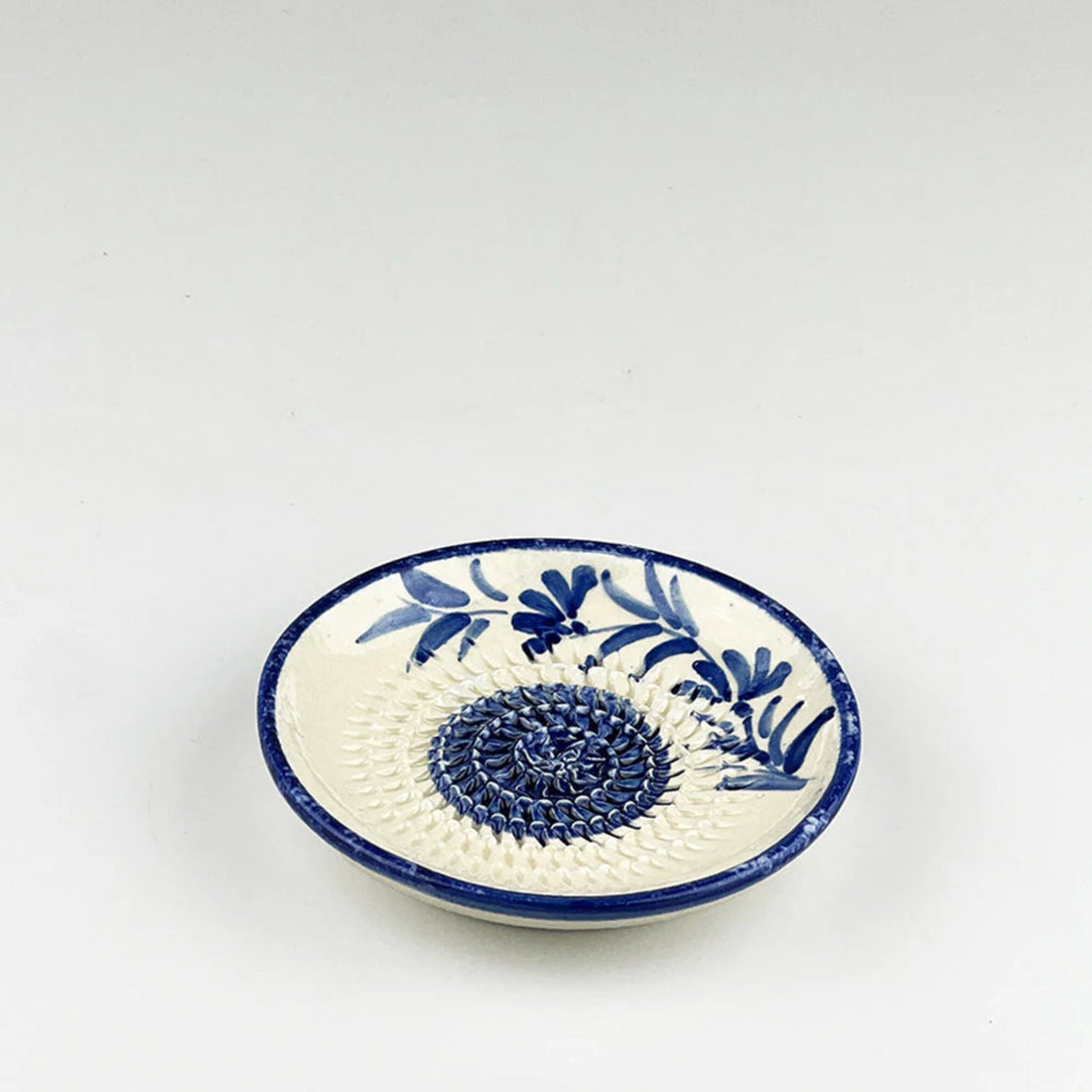Ceramic dish with blue floral patterns on a white background
