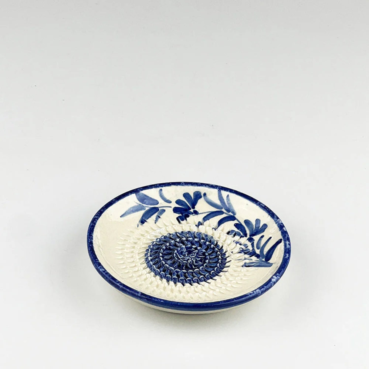 Ceramic dish with blue floral patterns on a white background