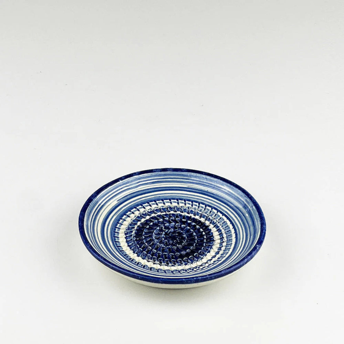 Ceramic bowl with blue and white pattern on a white background