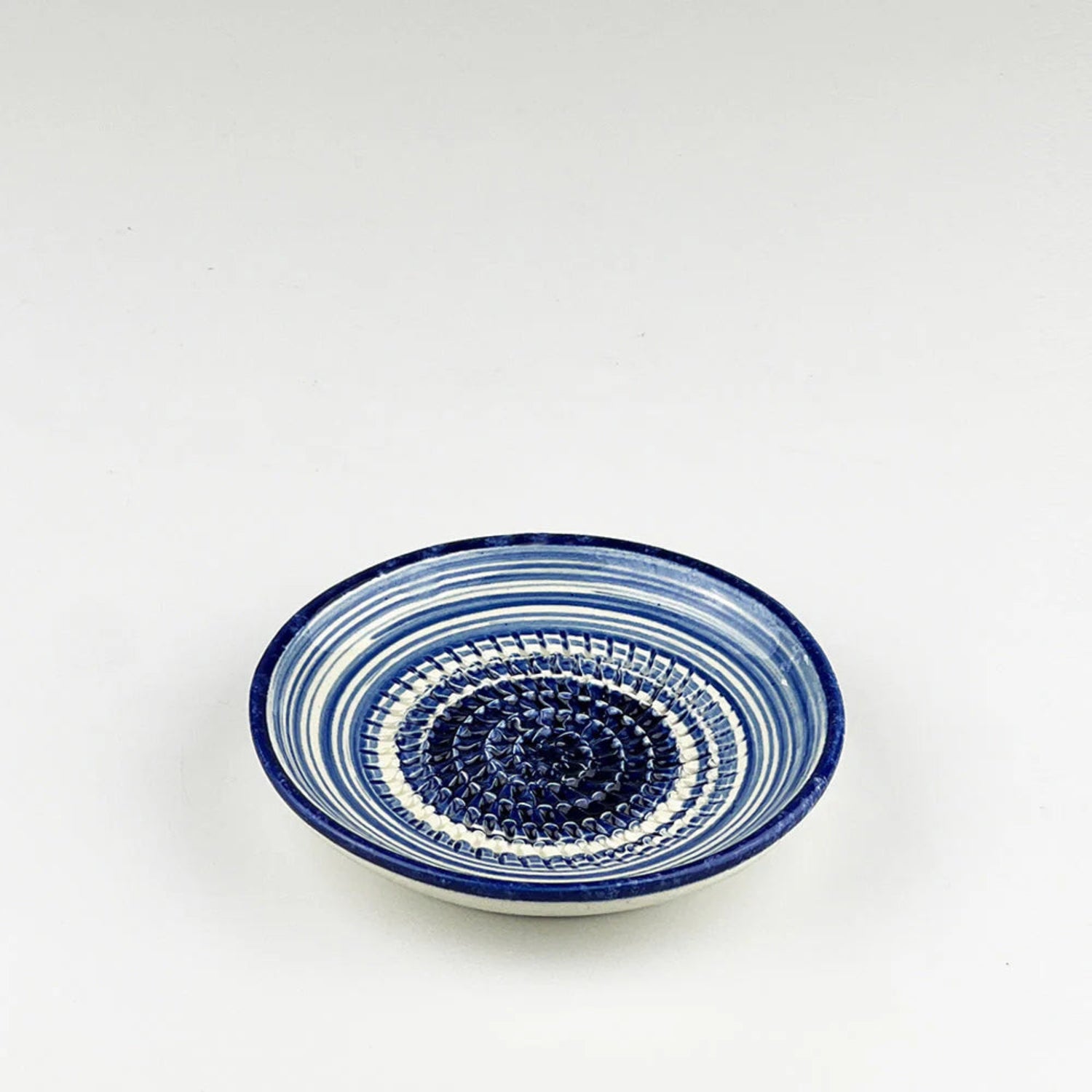 Ceramic bowl with blue and white pattern on a white background