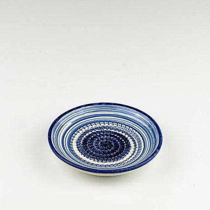 Ceramic bowl with blue and white pattern on a white background