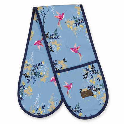 Pair of oven mitts with hummingbird and floral pattern on a blue background