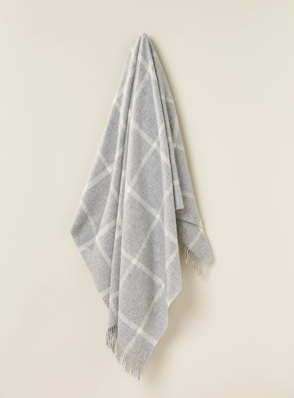 a grey and white plaid blanket on a hook