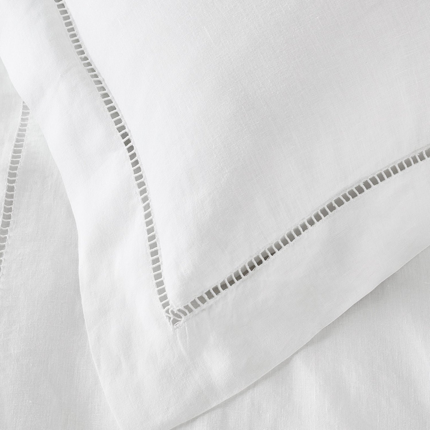 Close-up of white fabric with decorative stitching