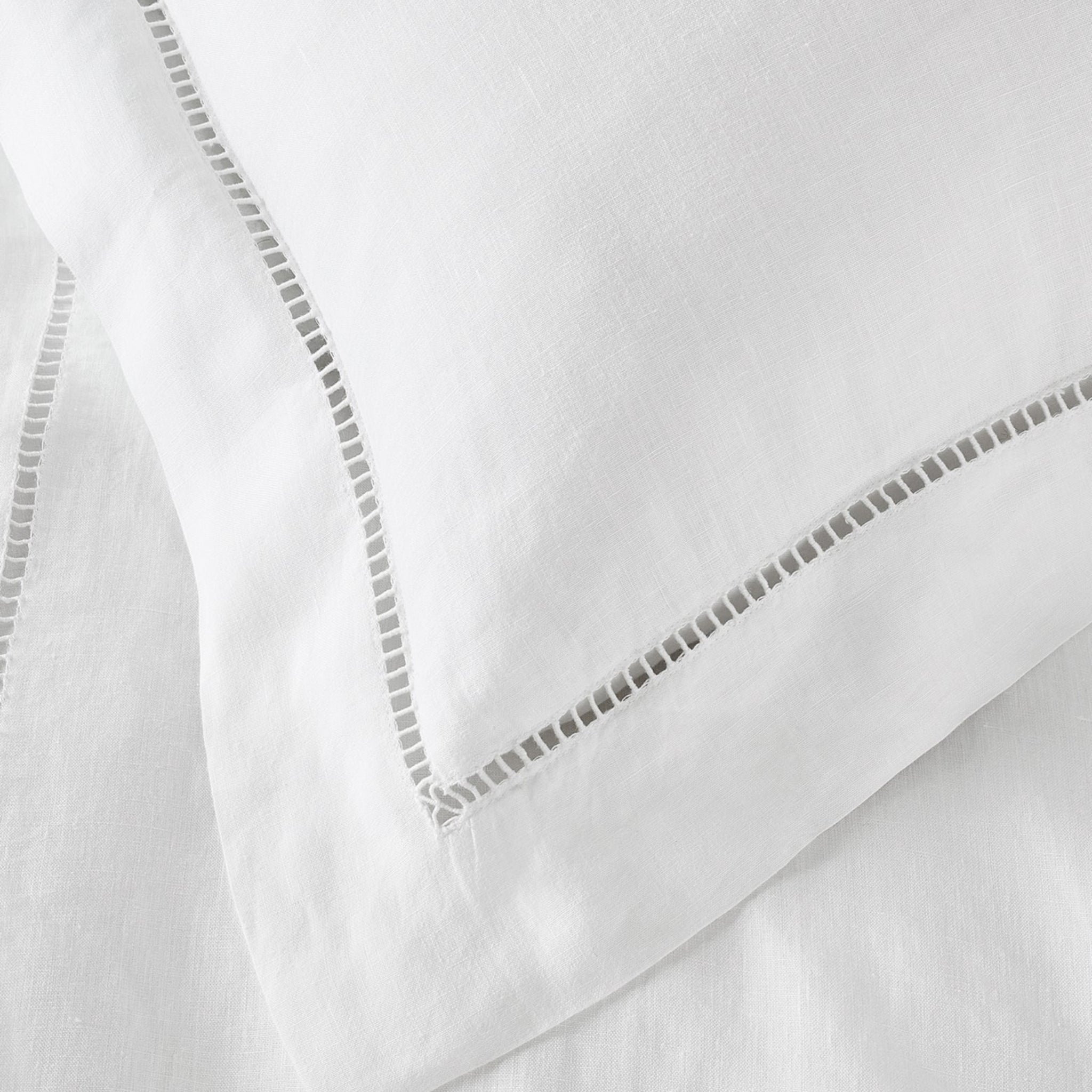 Close-up of white fabric with decorative stitching
