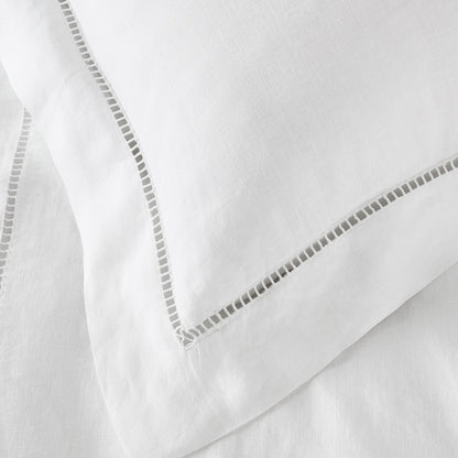 Close-up of white fabric with decorative stitching