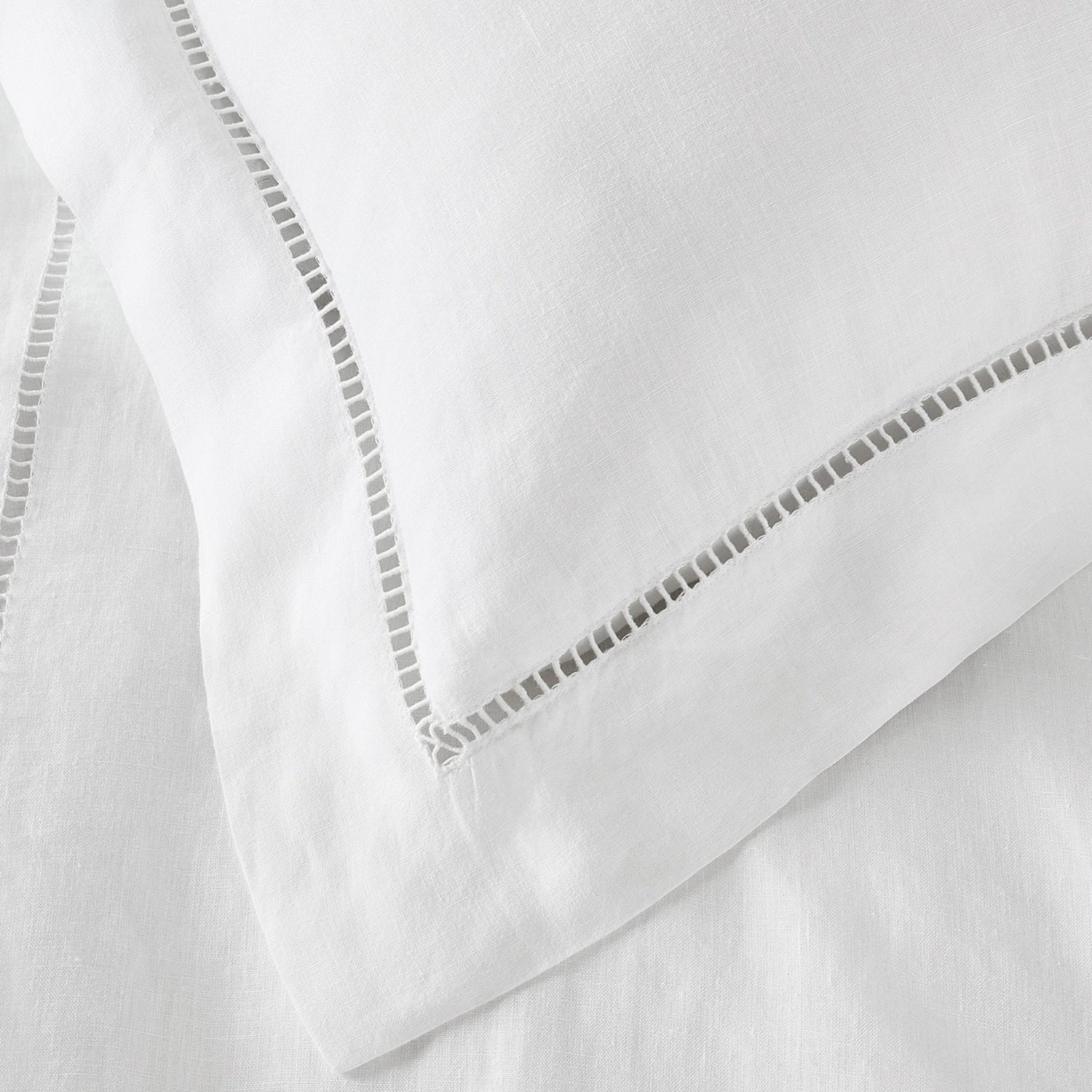 Close-up of white fabric with decorative stitching