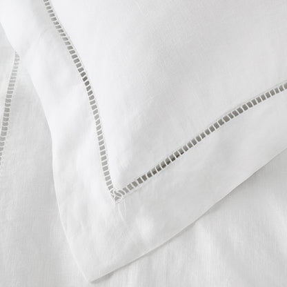 Close-up of white fabric with decorative stitching