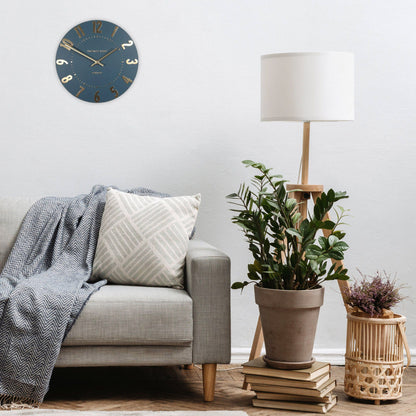 Living room with a gray sofa, plant, and lamp.