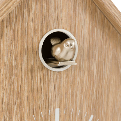 Wooden birdhouse with a small bird figurine peeking out of the entrance hole.