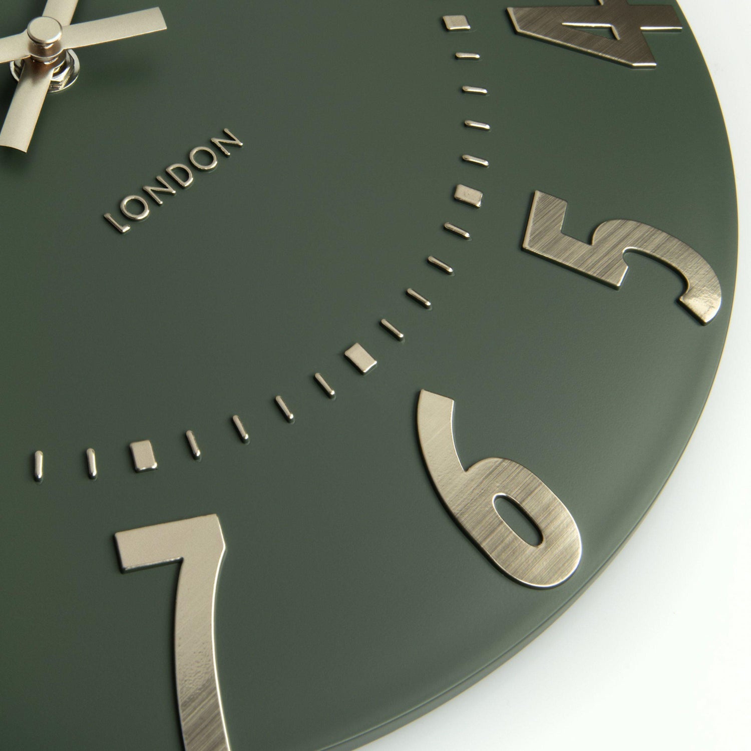 Green clock face with metallic numbers and &