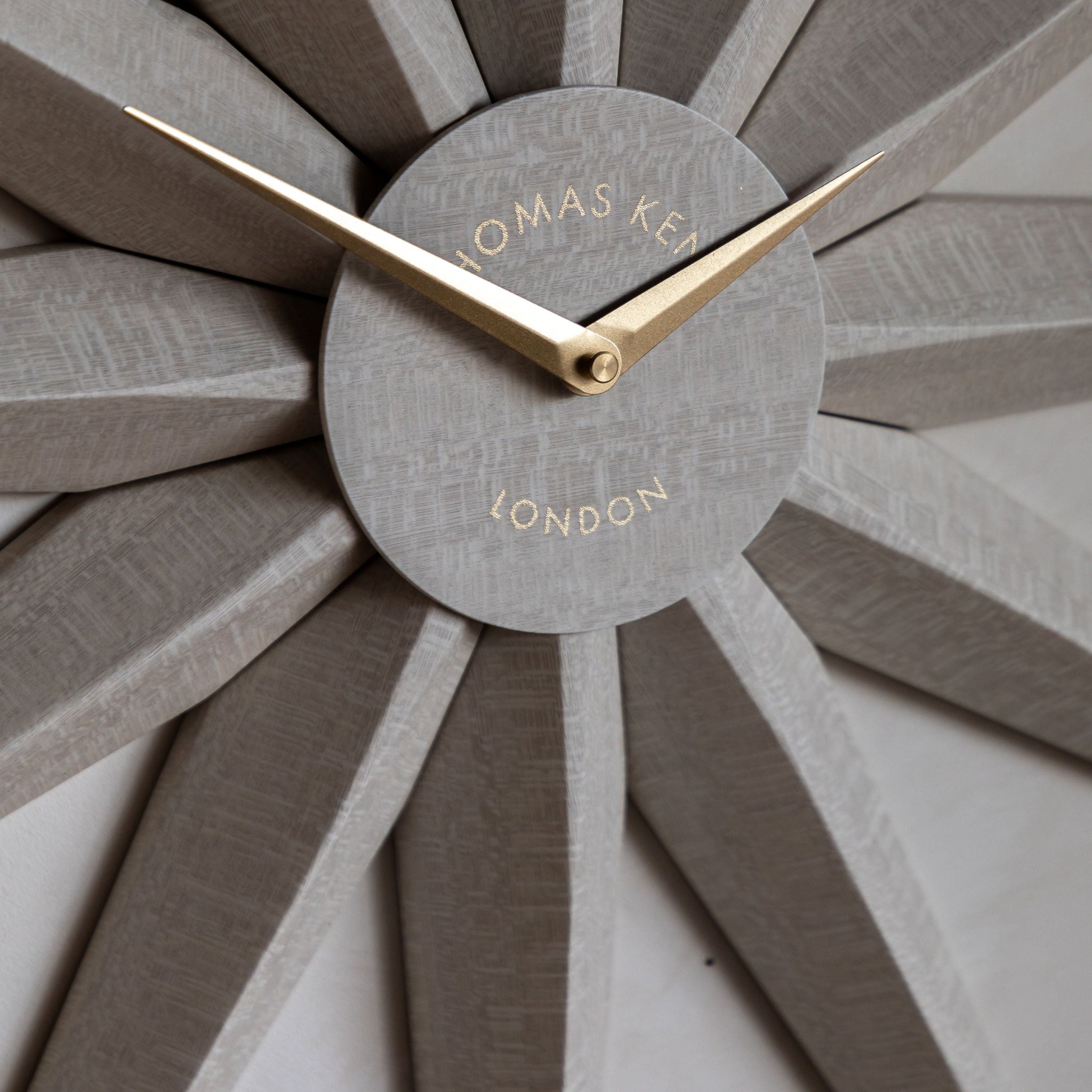 Wall clock with sunburst design and &