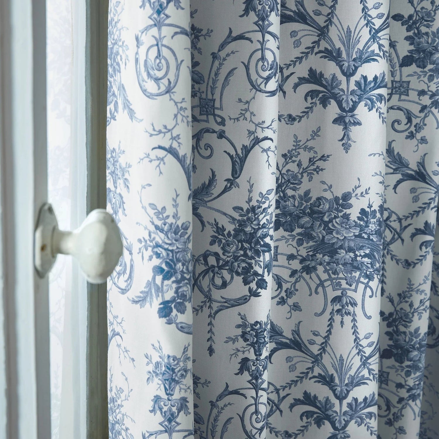 Curtain with blue floral pattern on a white background