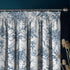 Floral patterned curtain with decorative elements on a dark background