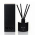 Black diffuser with sticks and packaging labeled &