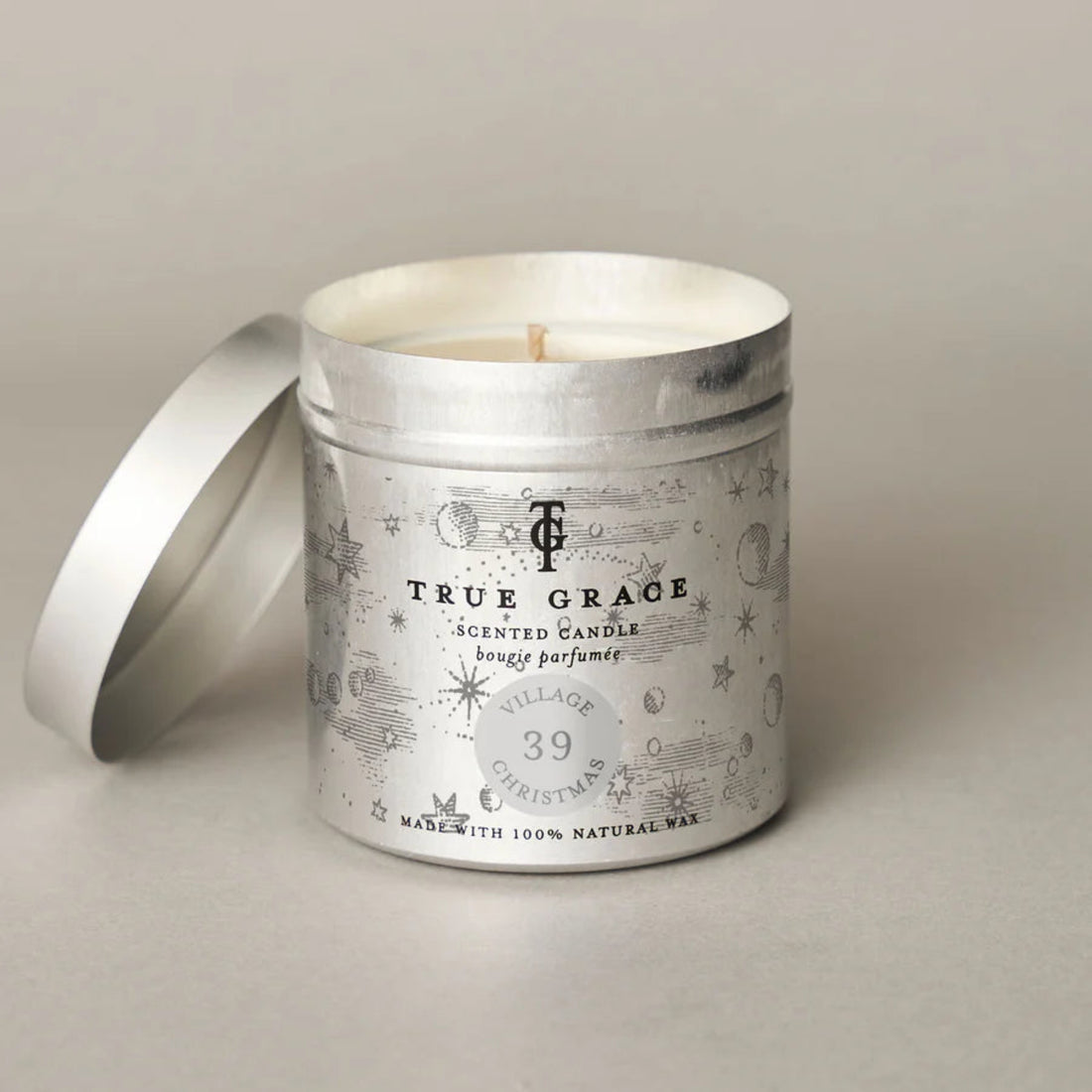 True Grace Christmas Village scented candle with decorative label on a neutral background