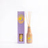 Wooden diffuser bottle with sticks and packaging on a white background