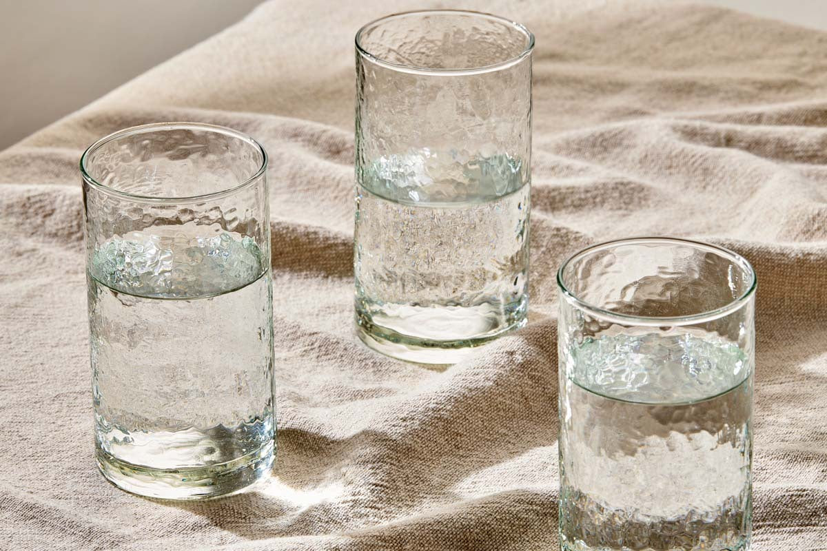 a group of glasses with water on a cloth