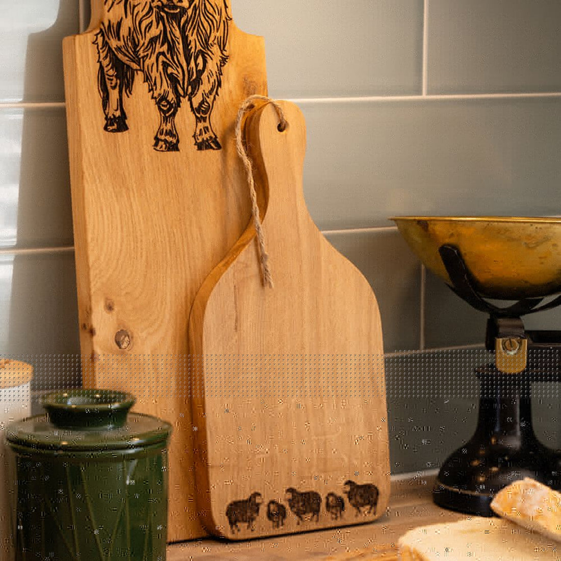 Two wooden cutting boards with engraved designs on a kitchen counter.