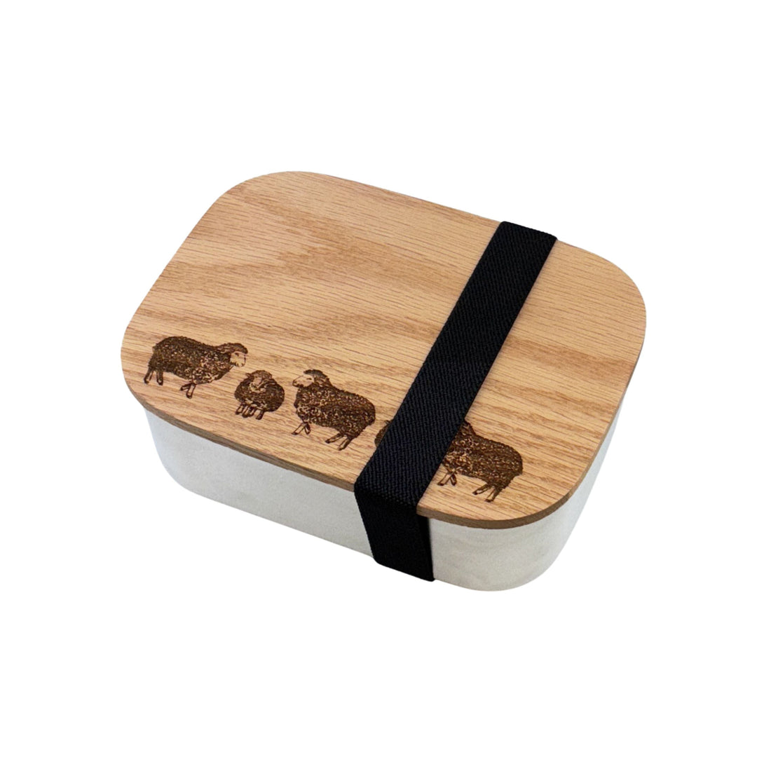 Wooden lunch box with black strap and engraved design of sheep on a wooden oak top
