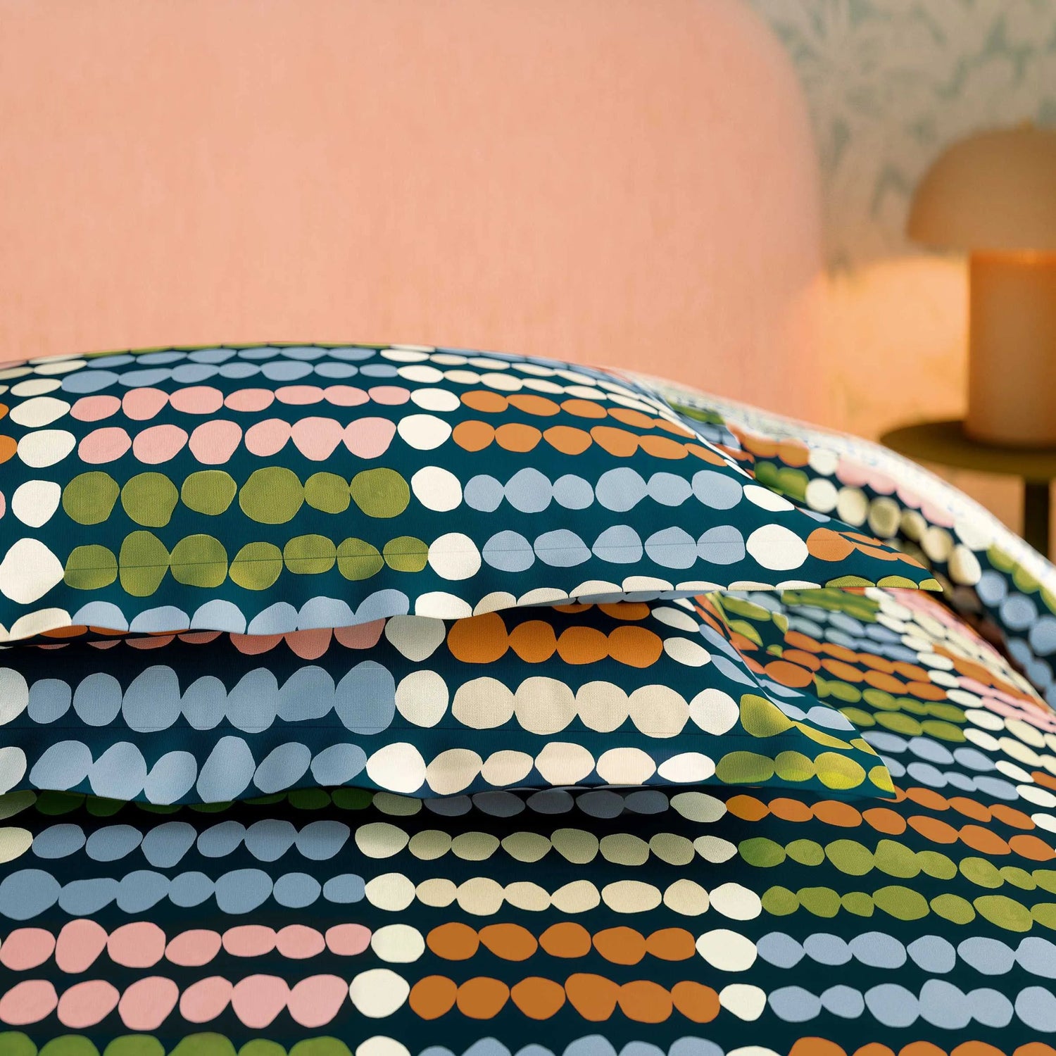 Colorful polka dot pattern on a bedspread in a bedroom setting
