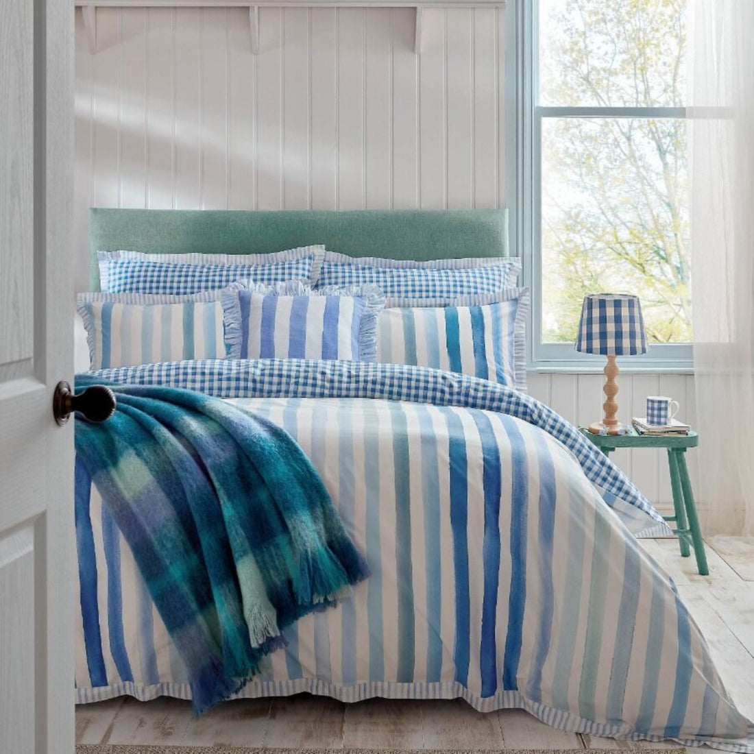 Bedroom with blue and white striped bedding and decor