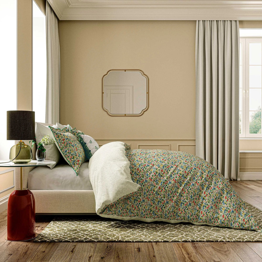 Neatly made bed with floral bedding in a bedroom setting.