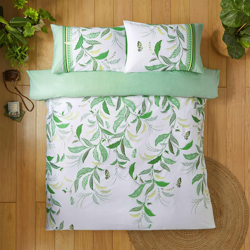 a bed with a green and white bedding